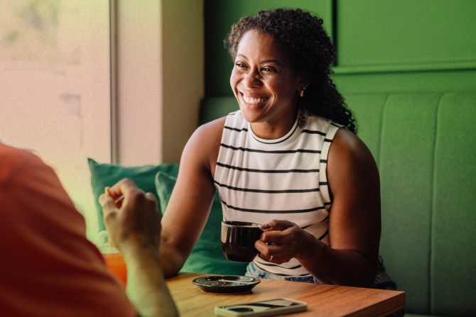 a woman smiling while having a good, free-flowing chat because she had solid conversation starters