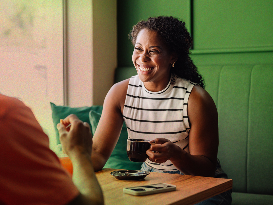 a woman smiling while having a good, free-flowing chat because she had solid conversation starters