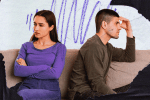 Two people turned away from each other on the couch and tension between them to illustrate relationship OCD