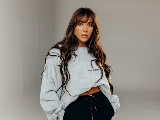 Kelsey Wells wearing a gray sweatshirt