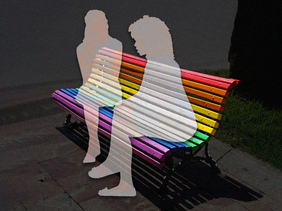 someone who came out late in life talking to their friend about it, both sitting on a rainbow bench