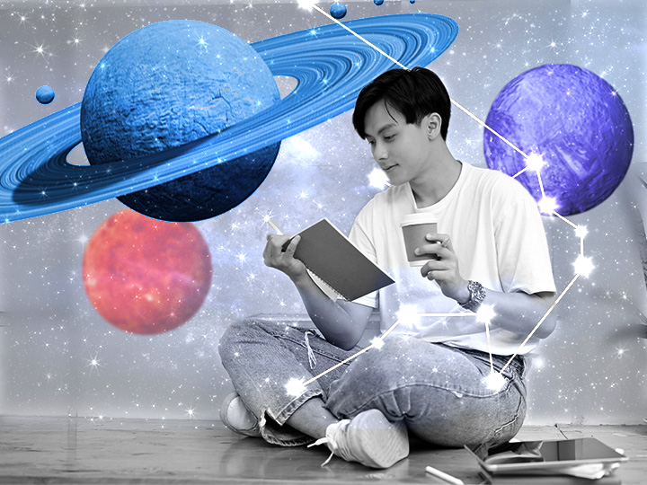 the planets around a person sitting down reading a book