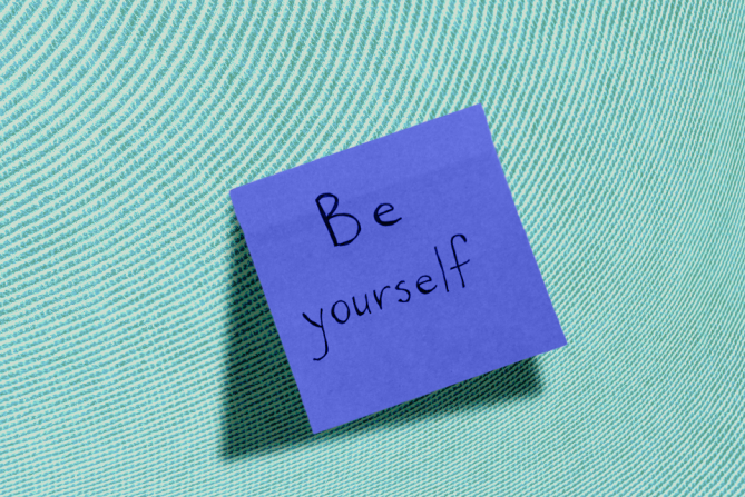 A sticky note that says "be yourself"