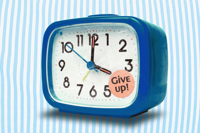 Alarm clock with a sticker that says "Give up"