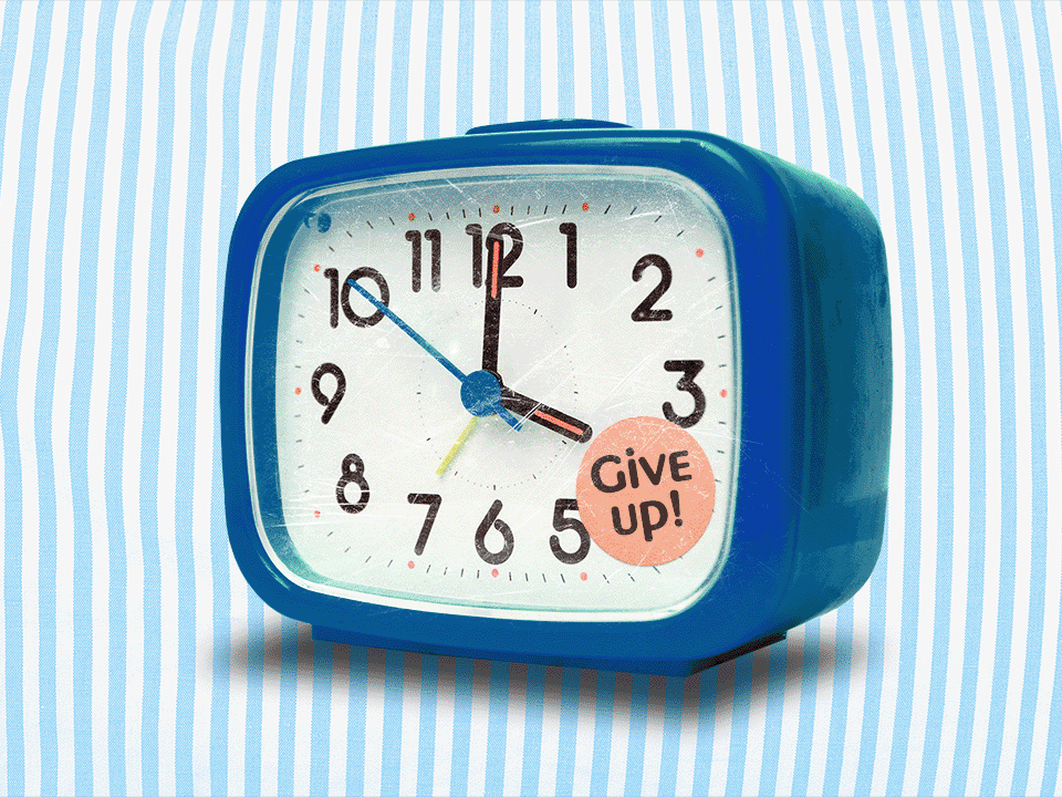 Alarm clock with a sticker that says "Give up"