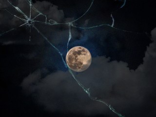 A full moon, clouds, and cracked glass, all signaling impending doom