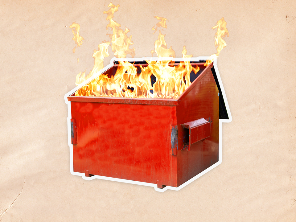 a red dumpster on fire