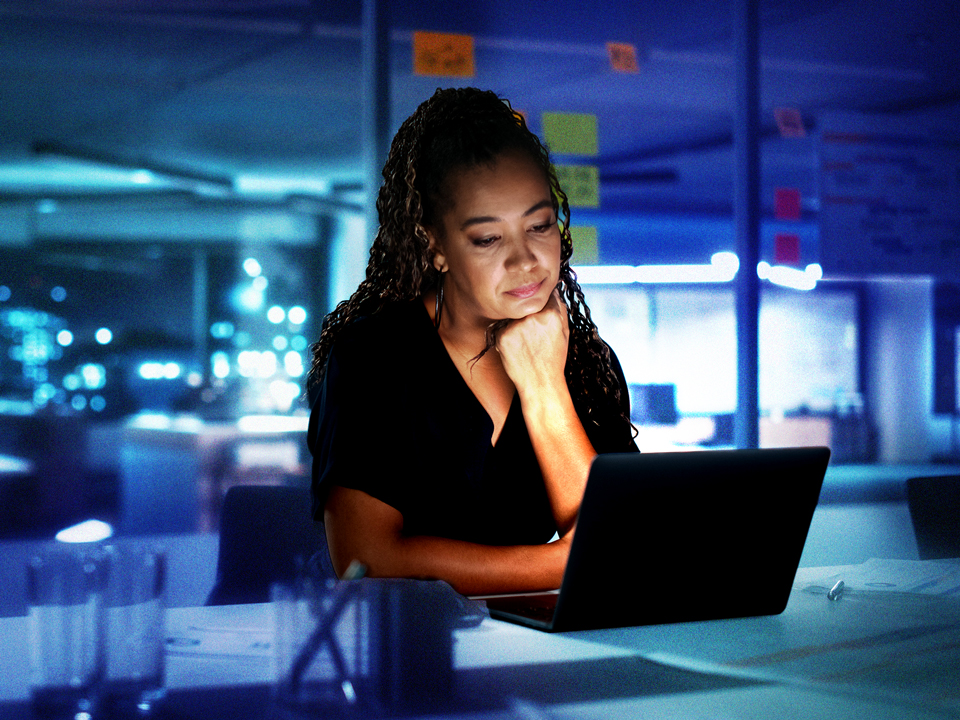 A woman working late because she is a workaholic