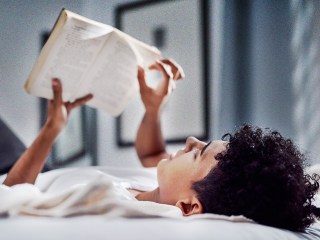 A man reading a book with social anxiety tips